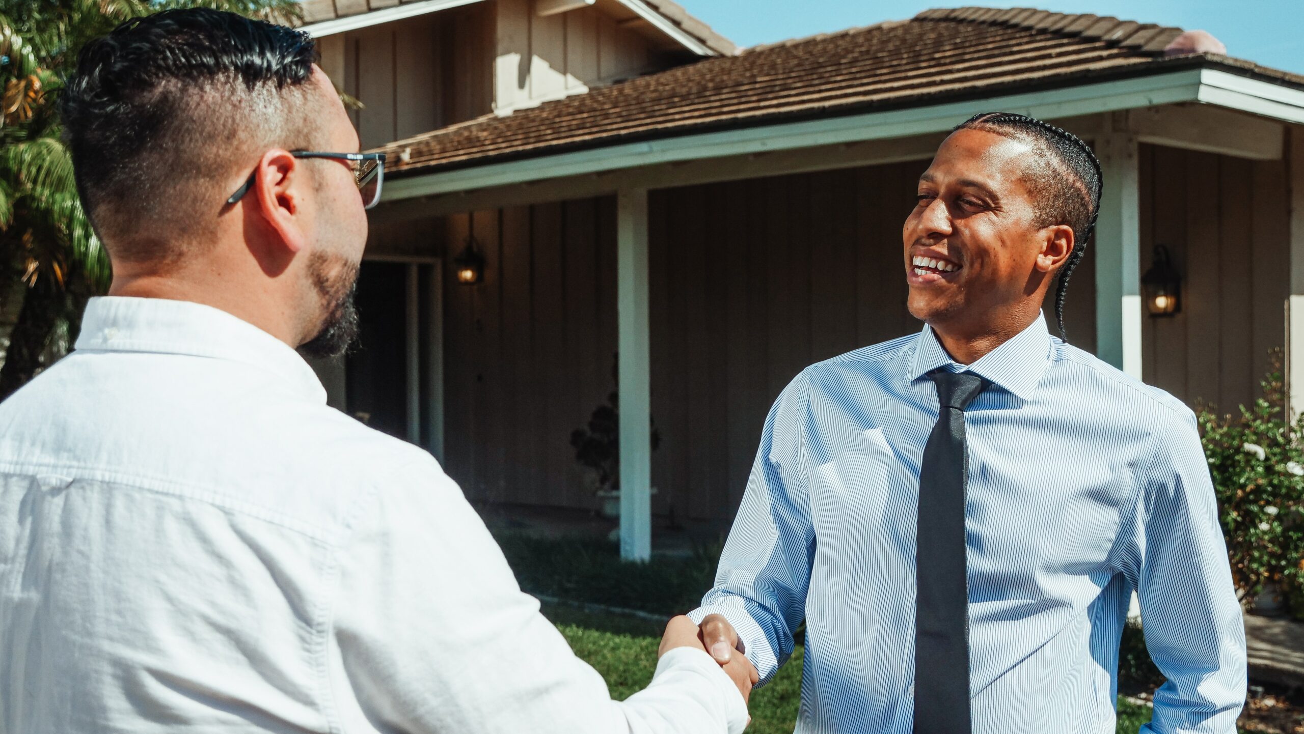 roofing sales two men handshake business outside home