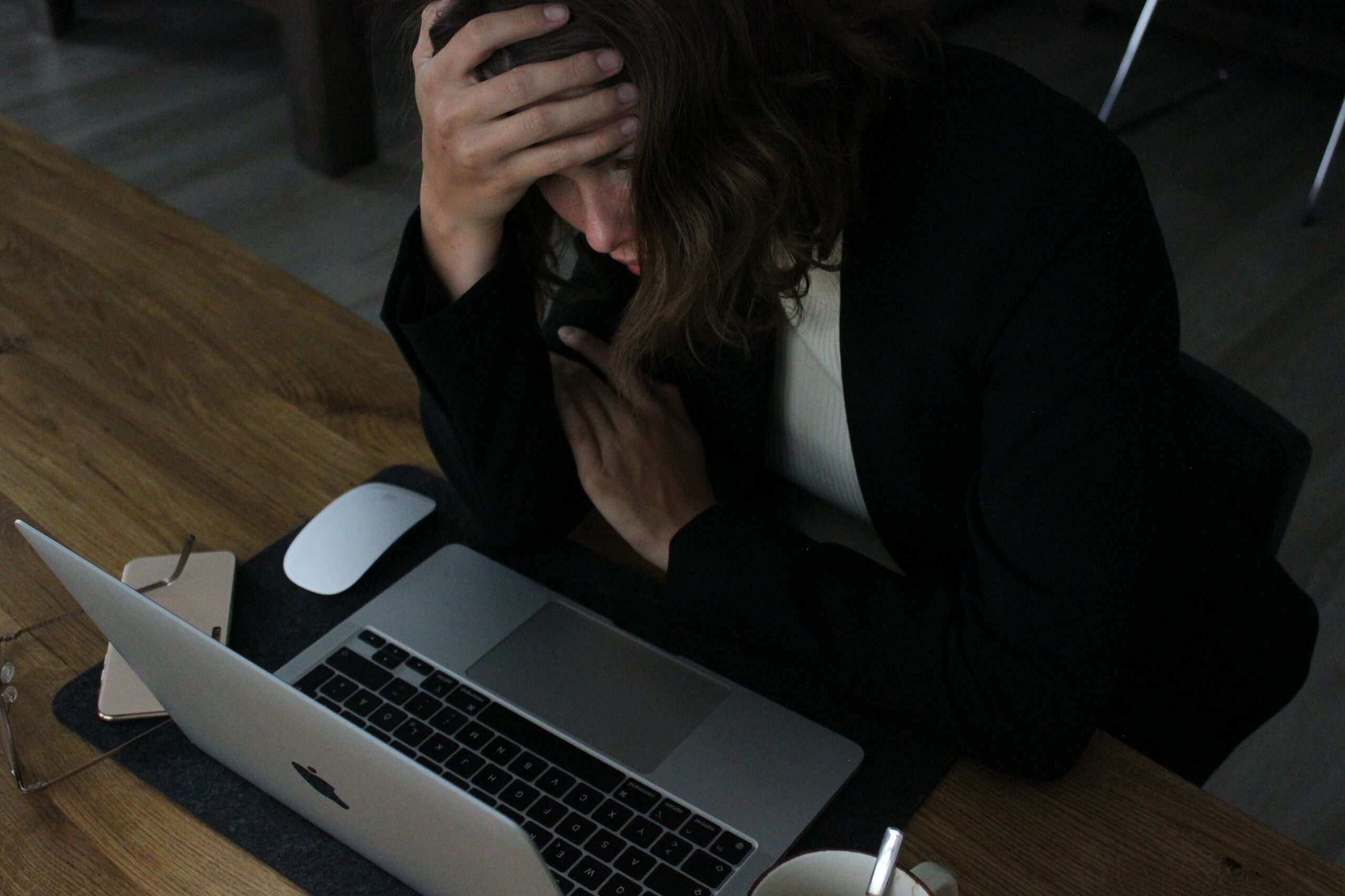 a business woman who is stressed and frustrated with laptop