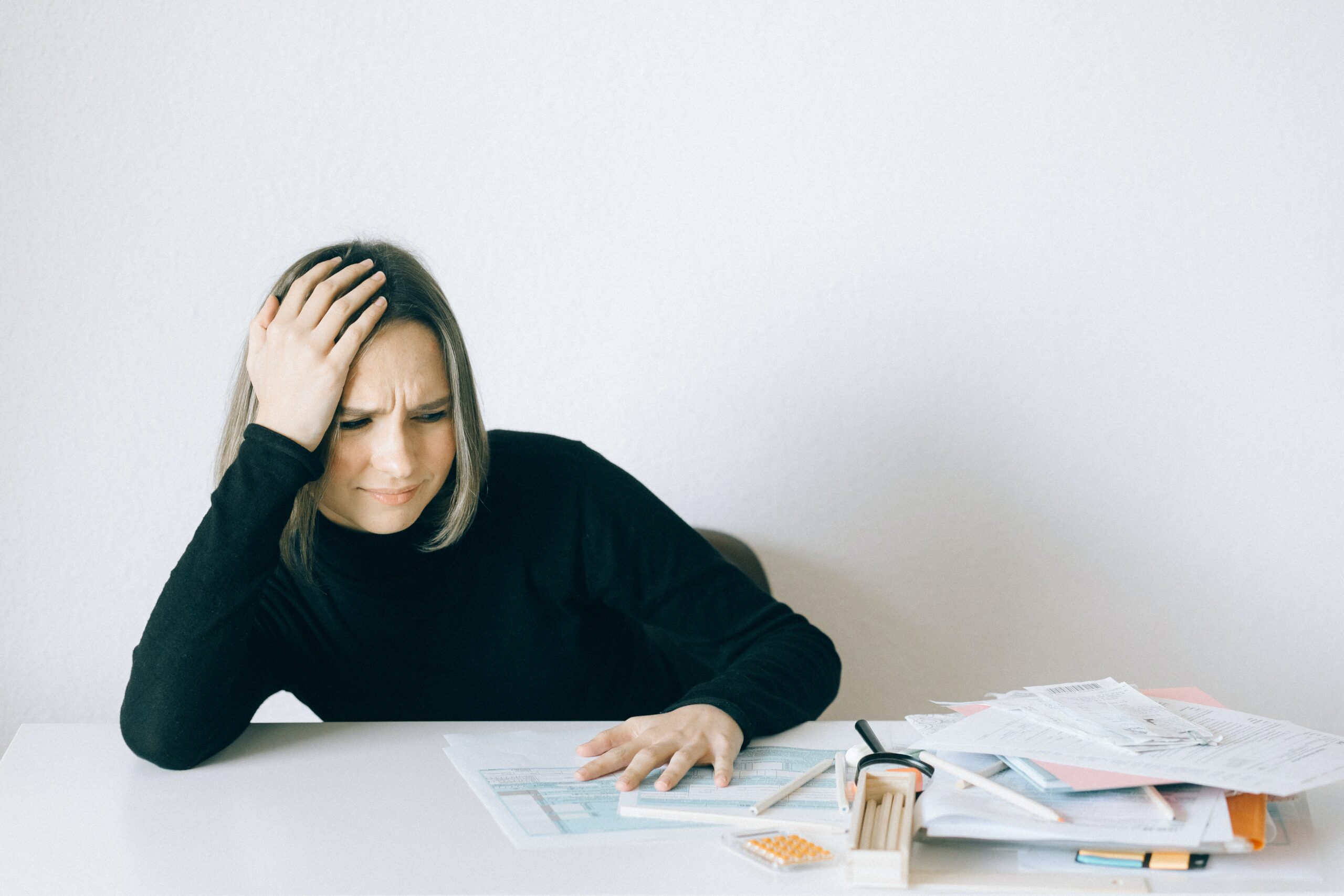 woman reading incident reporting paperwork stressed