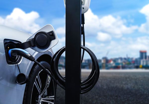 Use Case - EV Charging 49 ev charging station plugged into silver car blue sky