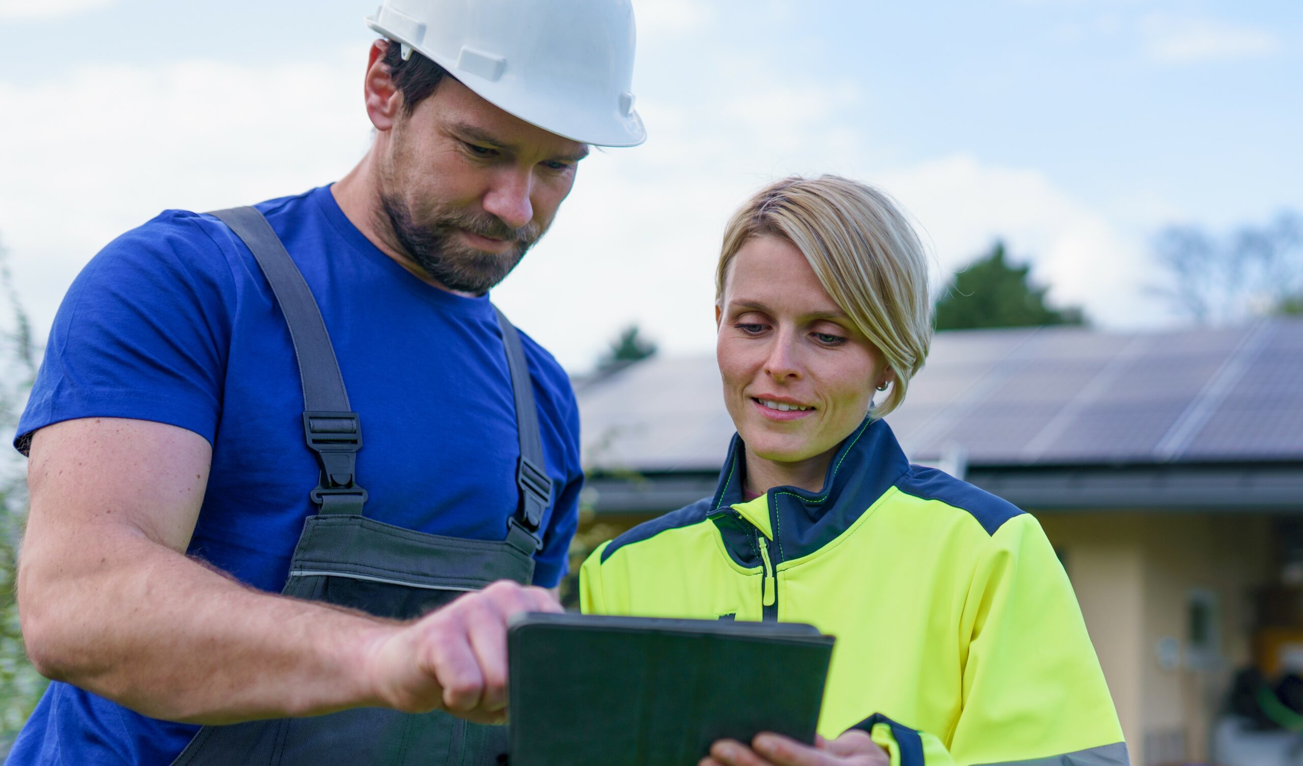 solar energy field technicians using field service software tablet