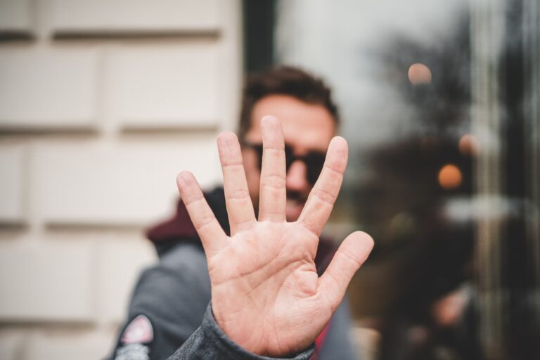 man holding five fingers up