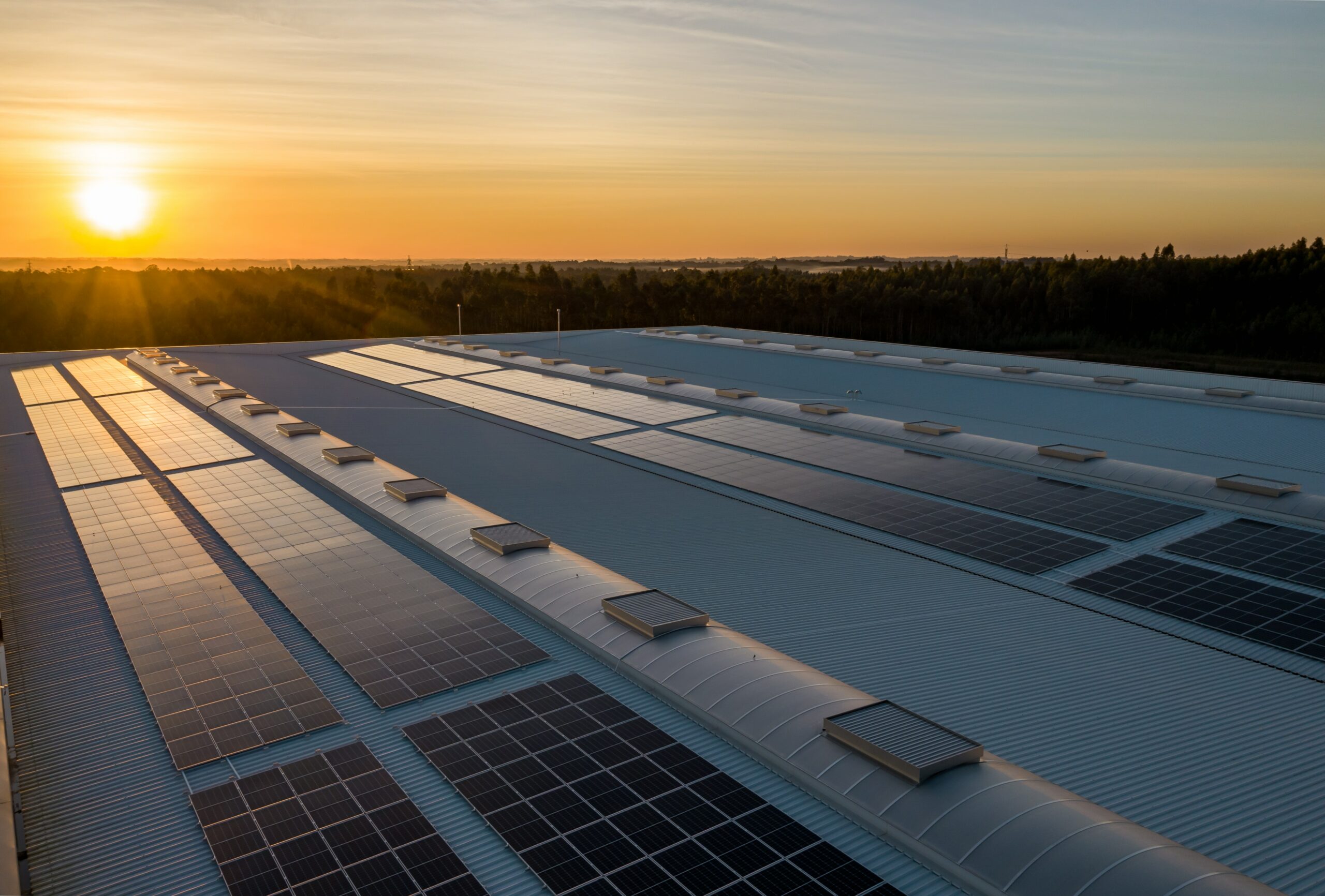 commercial solar project rooftop sunset scaled