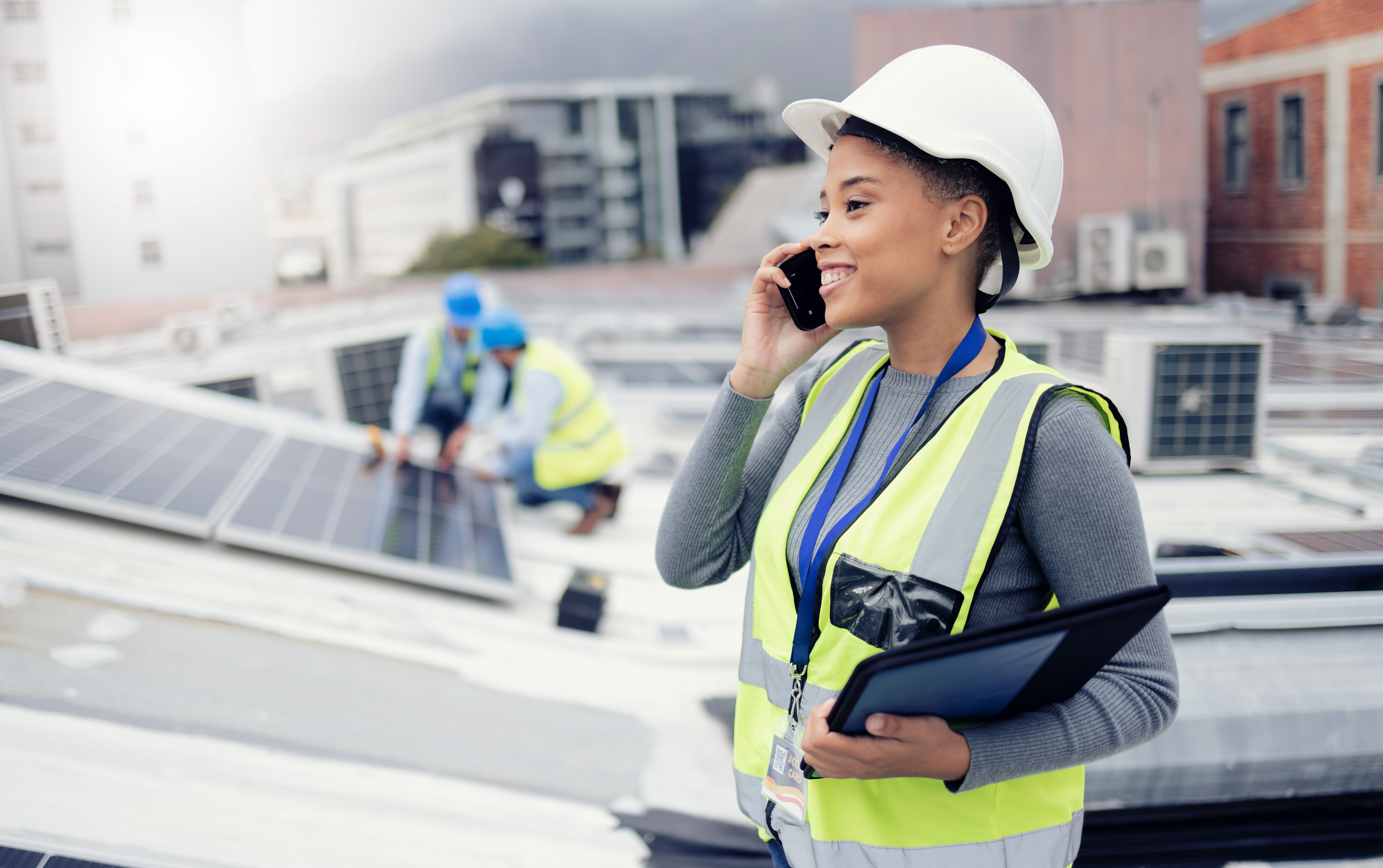 Solar energy, solar panels and electrician on a phone call networking, talking or speaking to a technician. Engineering, roof and happy woman in conversation or communication about renewable energy.