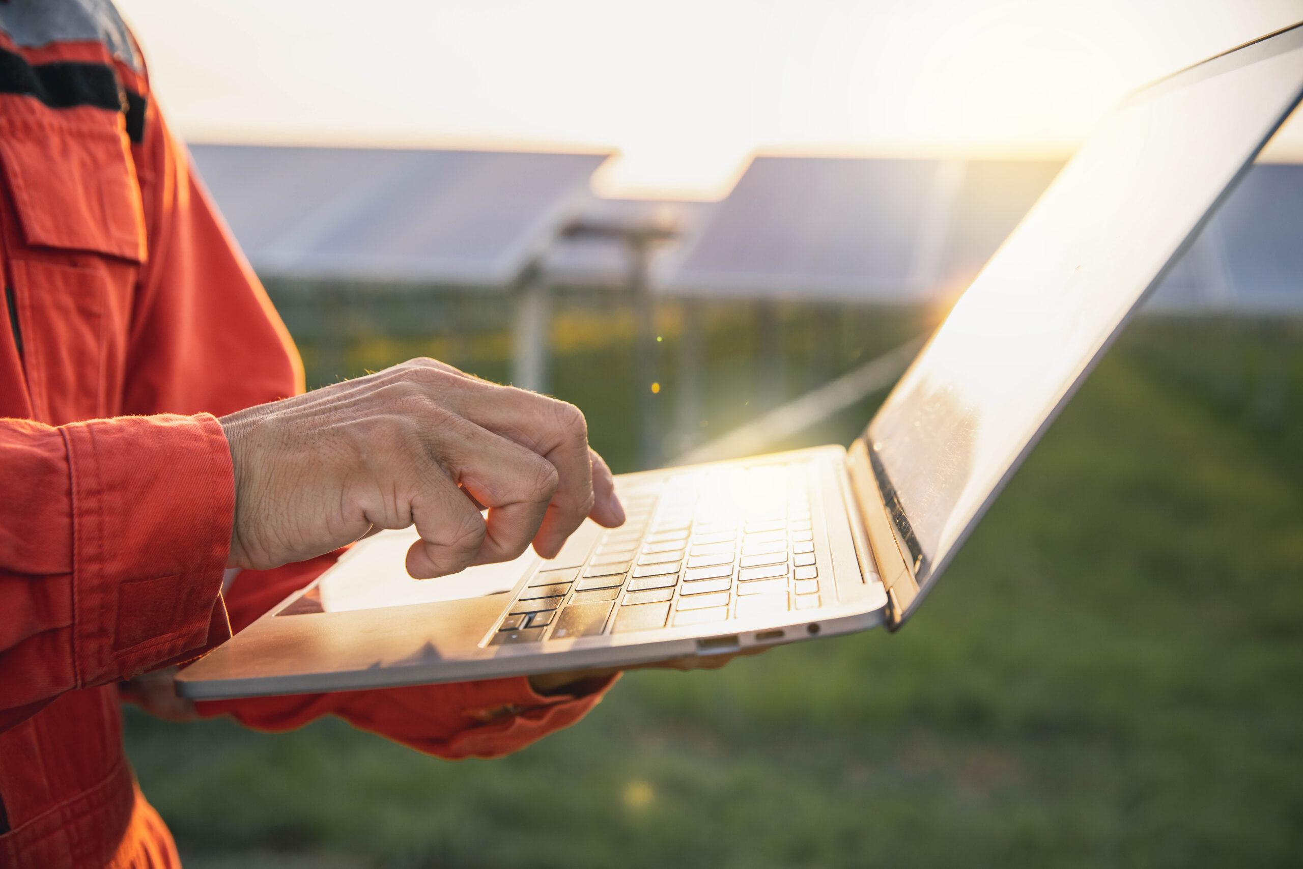 commercial solar farm project manager laptop sunny scaled