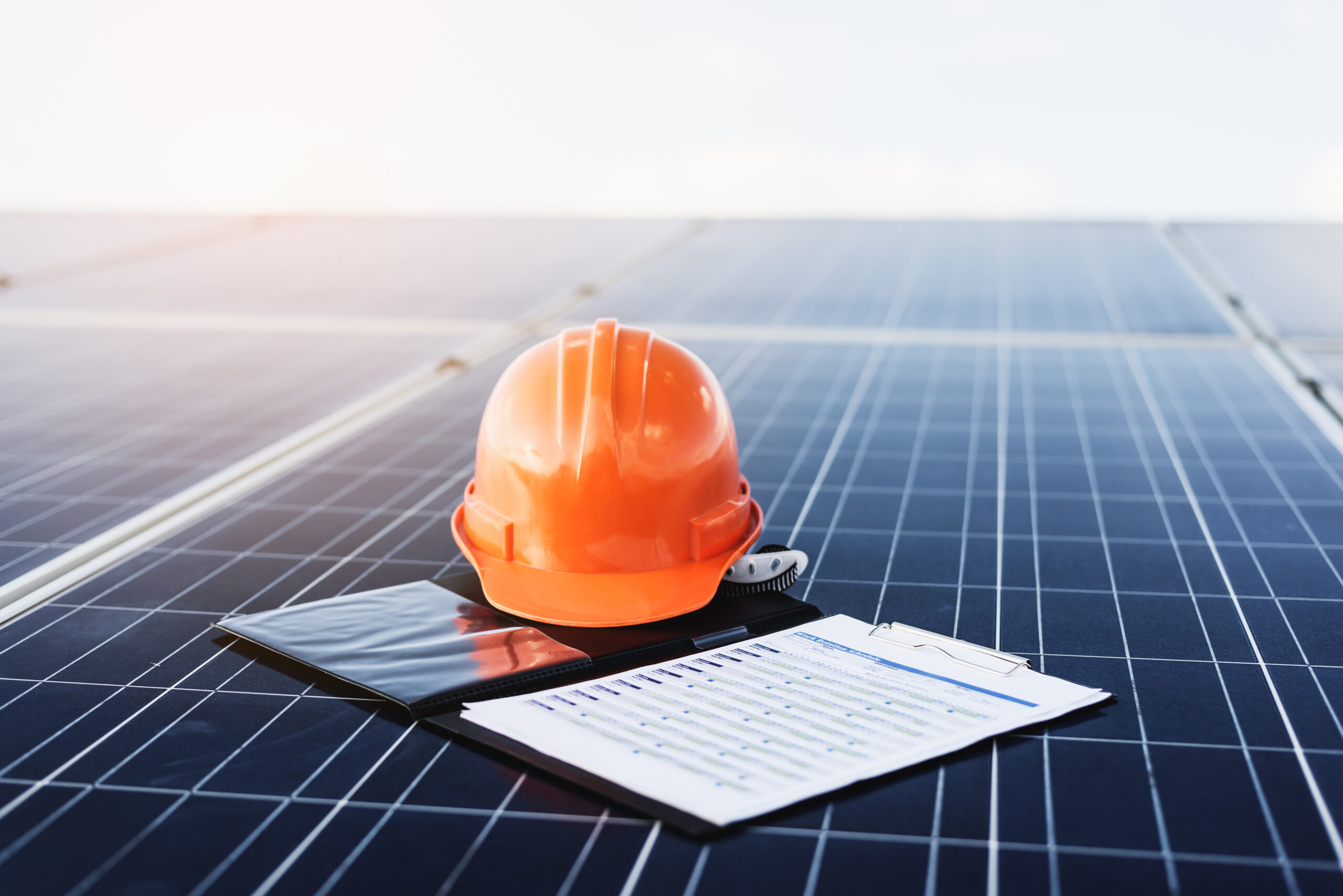 Orange helmet and documents On solar cells